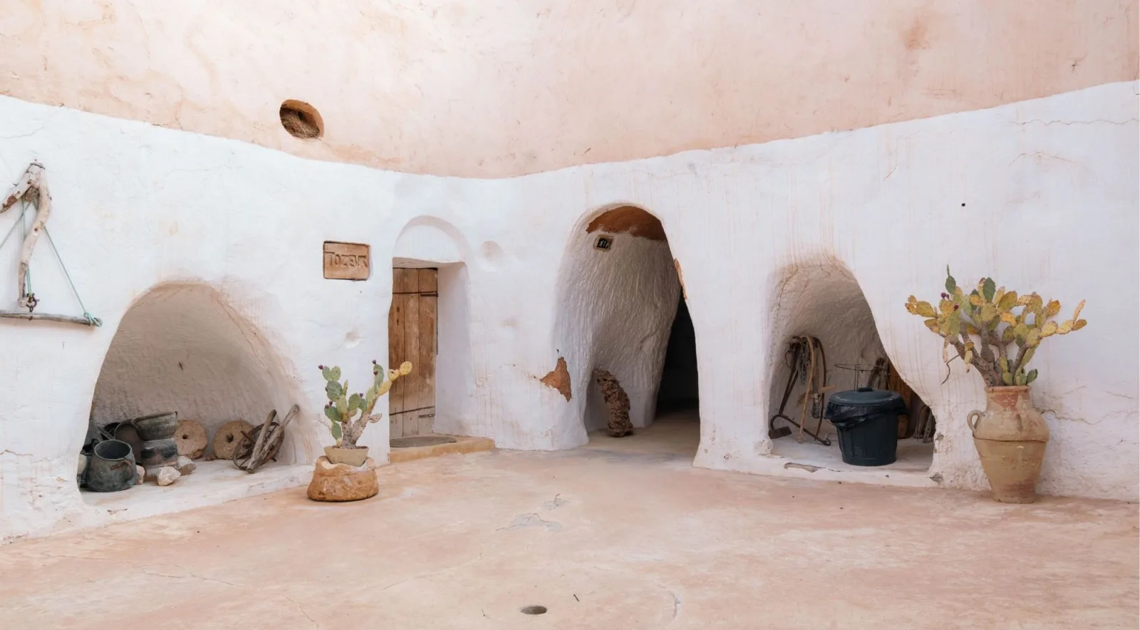 The whitewashed courtyard of a troglodyte house at Matmata with arched cave doorways
