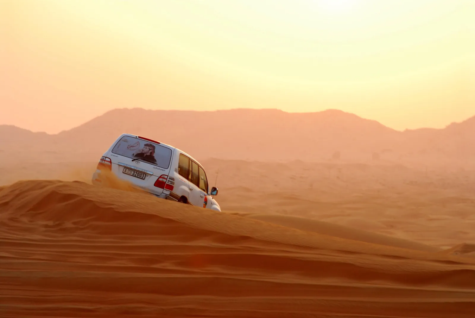 A 4x4 cresting a dune on the run into the erg